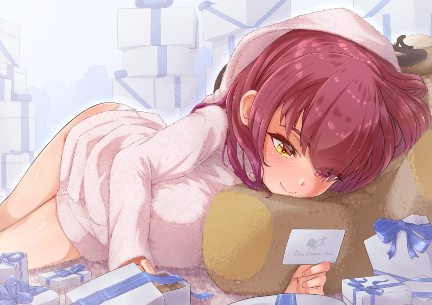 1girl bangs bathrobe berotore blush box breasts card closed_mouth full_body gift gift_box heterochromia highres holding holding_card hololive houshou_marine large_breasts long_hair looking_at_object lying on_stomach red_eyes redhead smile solo twisted_torso virtual_youtuber white_day yellow_eyes