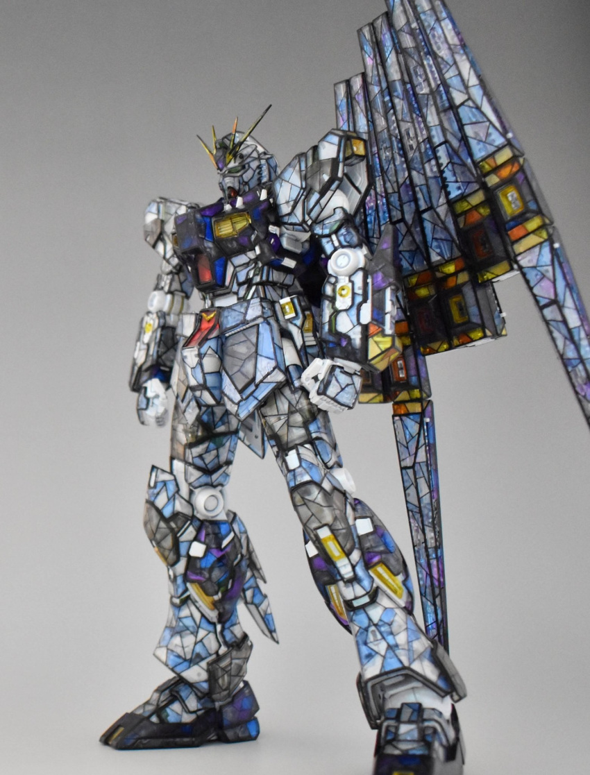 char's_counterattack clenched_hands fin_funnels gundam gunpla highres looking_down mecha mobile_suit model_kit no_humans nu_gundam photo_(medium) plamo science_fiction solo stained_glass standing sui_(sui4121) v-fin