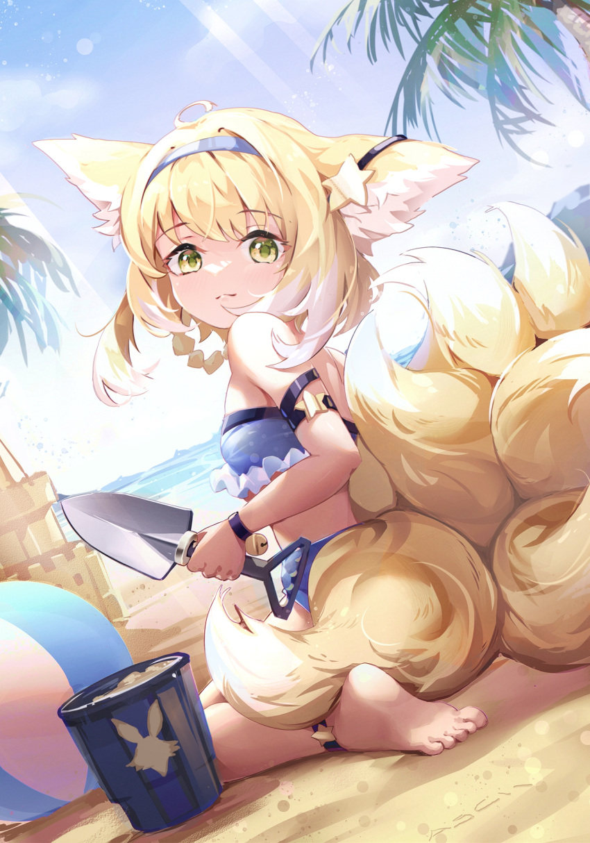 1girl animal_ears anklet arknights asc11 ball bandeau bangs bare_arms bare_shoulders barefoot beach beachball bikini blonde_hair blue_bikini blue_hairband blue_sky bucket chinese_commentary commentary_request day eyebrows_visible_through_hair fox_ears fox_tail hair_ornament hairband highres holding holding_shovel jewelry multiple_tails outdoors palm_tree revision sand_castle sand_sculpture short_hair shovel sitting sky solo star_(symbol) star_hair_ornament strapless strapless_bikini suzuran_(arknights) swimsuit tail tree wariza yellow_eyes