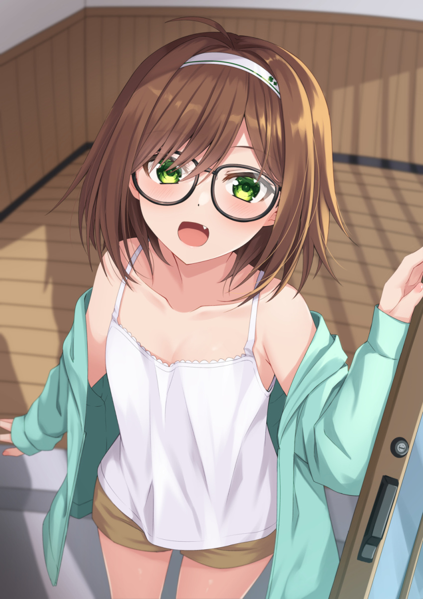 1girl :d ahoge aqua_jacket bangs bare_shoulders black-framed_eyewear blush brown_hair brown_shorts camisole collarbone commentary_request eyebrows_visible_through_hair fang glasses green_eyes hair_between_eyes hairband hand_up haru_(kuzuyu) highres indoors jacket komori_kuzuyu long_sleeves looking_at_viewer off_shoulder open_clothes open_door open_jacket open_mouth original short_shorts shorts sleeves_past_wrists smile solo standing white_camisole white_hairband wooden_floor