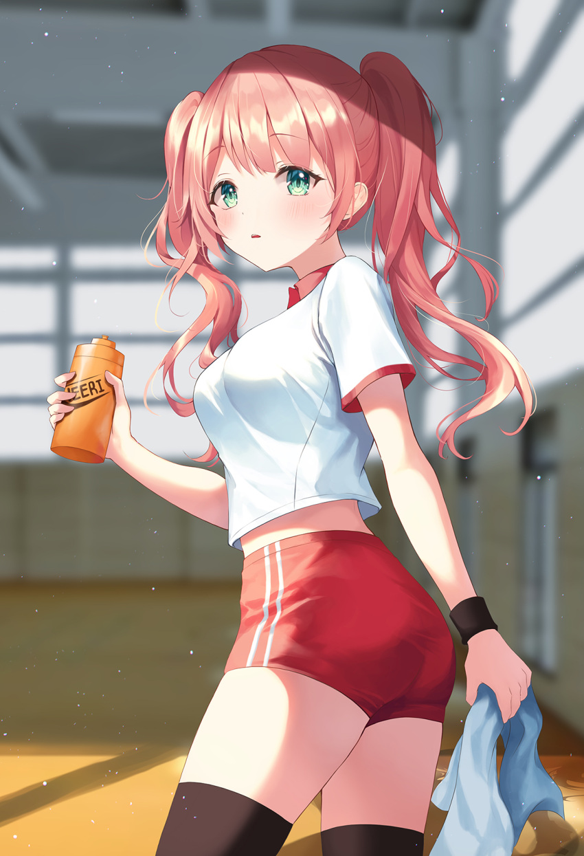 1girl ass bangs black_legwear blurry blurry_background blush bottle breasts commentary_request eyebrows_visible_through_hair green_eyes gym_uniform heeri highres holding holding_bottle holding_towel indoors long_hair looking_at_viewer medium_breasts open_mouth original pink_hair red_shorts shiny shiny_hair shirt short_shorts short_sleeves shorts solo thigh-highs towel twintails wristband
