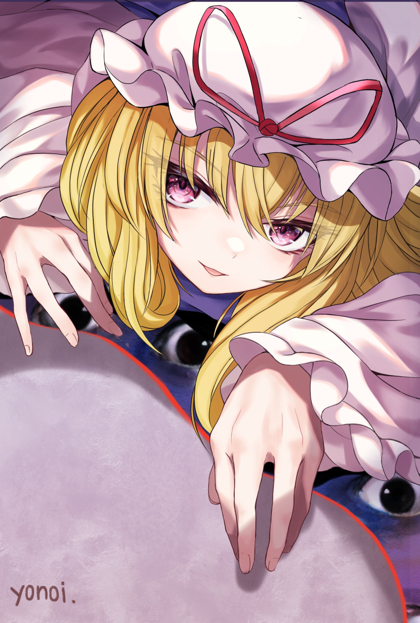 1girl absurdres artist_name bangs blonde_hair commentary_request crawling dress eyebrows_visible_through_hair eyes eyes_visible_through_hair fingernails gap_(touhou) hat hat_ribbon highres long_hair looking_at_viewer lying mob_cap on_stomach parted_lips red_ribbon ribbon smile solo tabard touhou upper_body violet_eyes white_dress white_headwear yakumo_yukari yonoisan