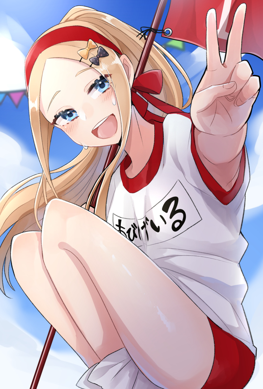 1girl abigail_williams_(fate) bangs blonde_hair blue_eyes blush breasts buruma fate/grand_order fate_(series) forehead gym_shirt gym_uniform headband highres kubomi_943 long_hair looking_at_viewer olympian_bloomers open_mouth parted_bangs red_buruma red_headband shirt sidelocks small_breasts smile solo