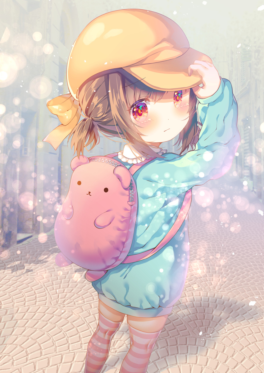 1girl absurdres animal_bag arm_up backpack bag bear_bag blue_shirt blush bow brown_hair brown_headwear cabbie_hat child closed_mouth collared_shirt commentary_request frilled_shirt_collar frills from_behind hand_on_headwear hat highres holding holding_clothes holding_hat loli long_sleeves looking_at_viewer looking_back original outdoors pavement ponytail red_eyes rokomoko shirt sidelocks solo standing striped striped_legwear striped_thighhighs thigh-highs yellow_bow