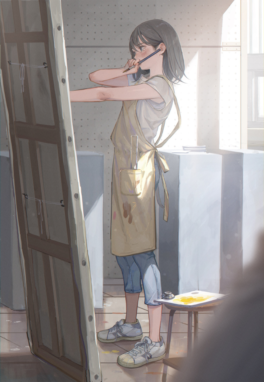 1girl absurdres apron bangs black_hair blush canvas_(object) commentary_request denim highres holding holding_paintbrush indoors jeans medium_hair original paintbrush painting palette pants shirt shoes short_sleeves sneakers solo standing stool sunlight t-shirt tearing_up tears utaka_(anyoanyot) white_shirt