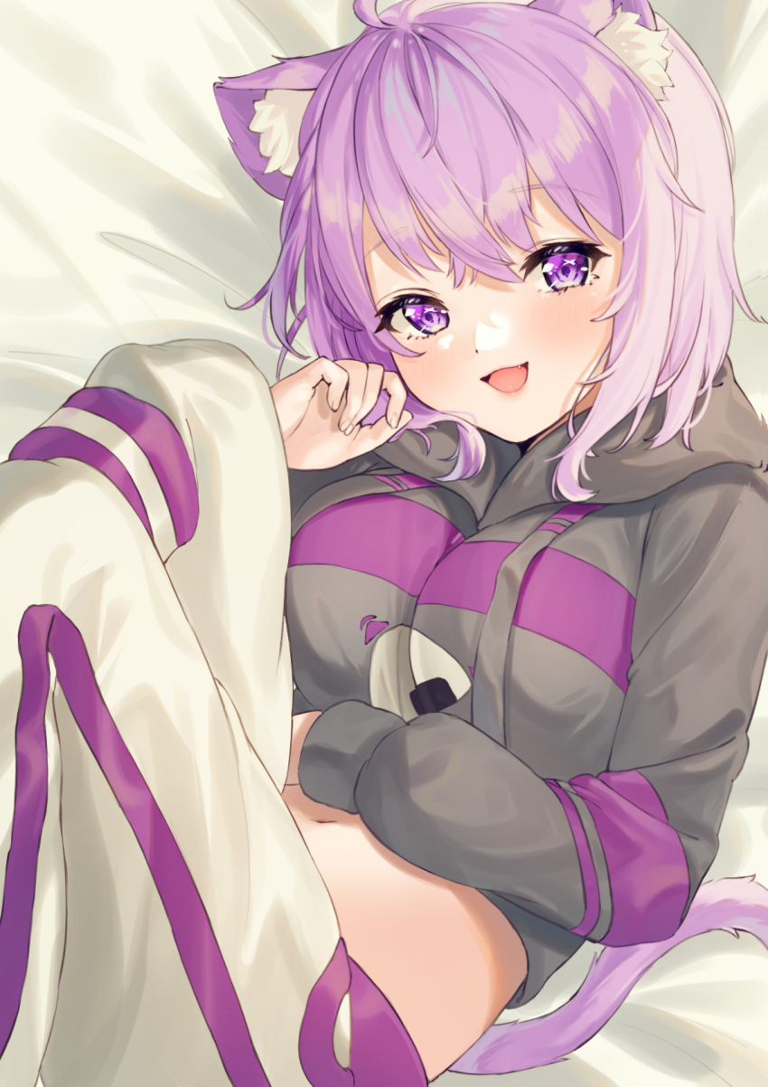 1girl :d ahoge animal_ear_fluff animal_ears bangs bed_sheet black_hoodie blush breasts cat_ears cat_girl cat_tail commentary cropped_hoodie drawstring eyebrows_visible_through_hair fang hand_on_own_stomach hand_up highres hiyorou hololive hood hood_down hoodie large_breasts long_sleeves looking_at_viewer lying medium_hair midriff navel nekomata_okayu on_back onigiri_print open_mouth pants purple_hair smile solo tail violet_eyes virtual_youtuber white_pants