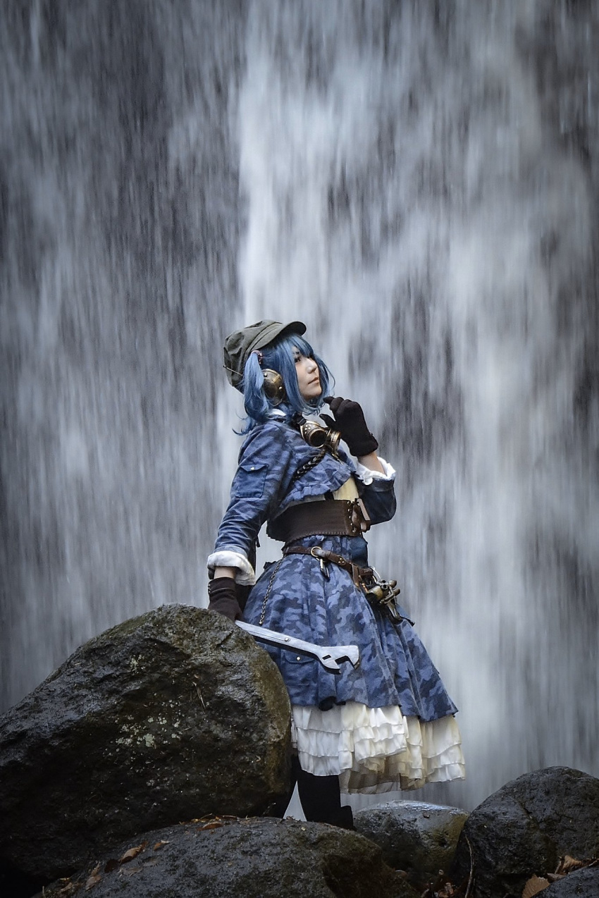 adapted_costume blue_hair blue_shirt blue_skirt brown_gloves closed_mouth cosplay from_side gloves hat highres holding holding_wrench kawashiro_nitori kawashiro_nitori_(cosplay) layered_skirt long_sleeves mametacos photo_(medium) shirt skirt standing tool_belt touhou water waterfall wrench