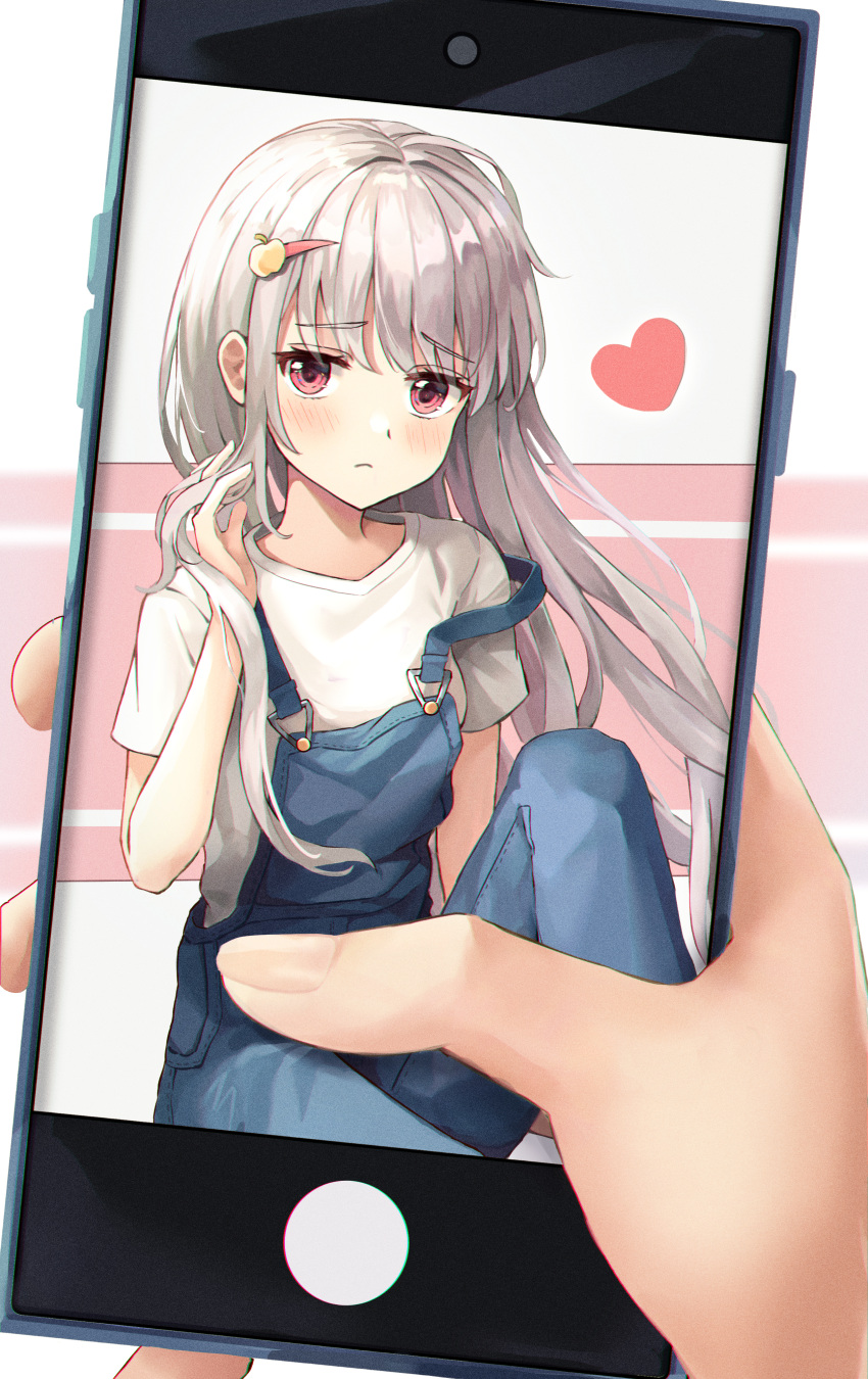 1girl absurdres bangs blush closed_mouth frown hair_ornament hairclip hand_in_hair hand_up heart highres holding holding_phone long_hair looking_at_viewer orange_eyes original overalls phone shirt short_sleeves silver_hair solo strap_slip white_shirt x4snow