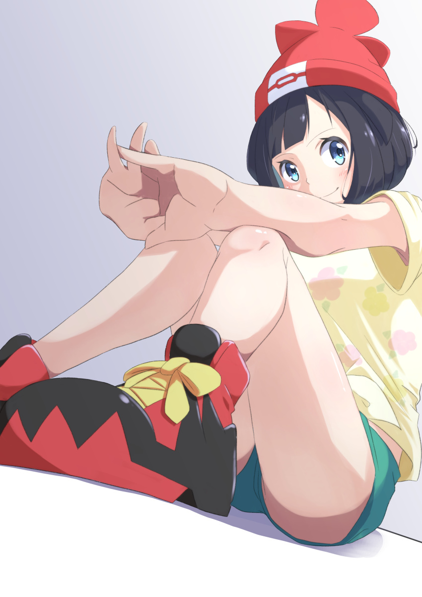 1girl absurdres bare_legs beanie black_hair blue_eyes closed_mouth commentary_request eyelashes floral_print from_below green_shorts hands_together hat highres negimiso1989 pokemon pokemon_(game) pokemon_sm red_headwear selene_(pokemon) shirt shoes short_hair short_shorts short_sleeves shorts sitting smile sneakers solo t-shirt