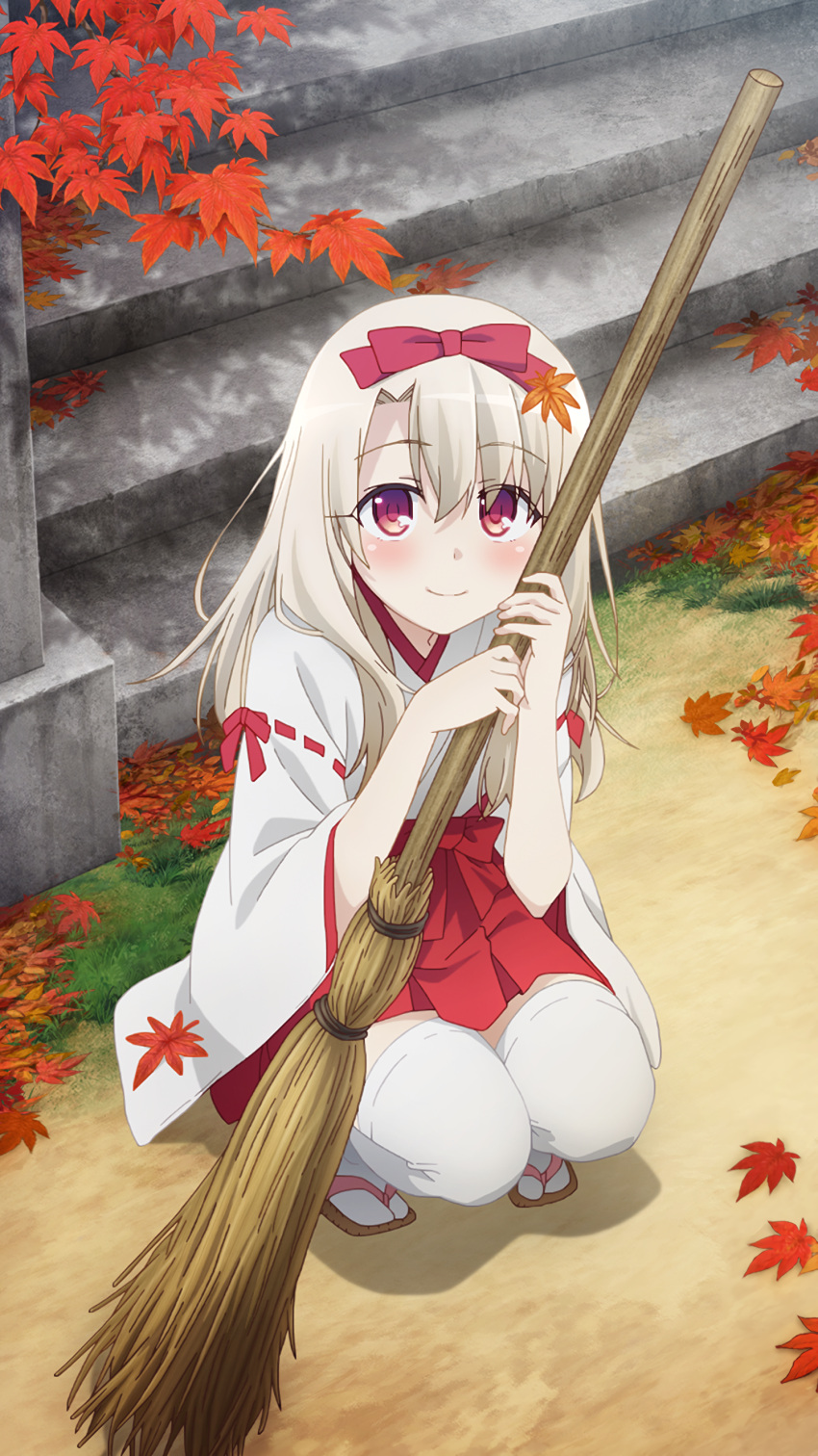 1girl absurdres blush bow broom closed_mouth day eyebrows_visible_through_hair fate/kaleid_liner_prisma_illya fate_(series) from_above game_cg hair_bow hakama_skirt highres illyasviel_von_einzbern japanese_clothes leaf light_brown_hair long_hair looking_at_viewer maple_leaf miko official_art outdoors red_eyes ribbon-trimmed_sleeves ribbon_trim sandals smile solo squatting thigh-highs white_legwear wide_sleeves