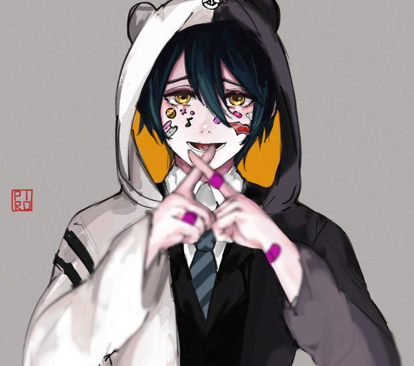 1boy animal_hood bandaid bandaid_on_hand bangs bear_hood black_hair black_jacket black_neckwear blurry blurry_foreground brown_eyes commentary cosplay dangan_ronpa_(series) dangan_ronpa_v3:_killing_harmony depth_of_field facepaint grey_background hair_between_eyes highres hood hood_up hoodie index_finger_raised jacket long_sleeves looking_at_viewer lower_teeth male_focus monokuma monokuma_(cosplay) necktie open_mouth pale_skin piro_(piropoi) saihara_shuuichi shirt short_hair solo sticker striped upper_body white_shirt yellow_eyes