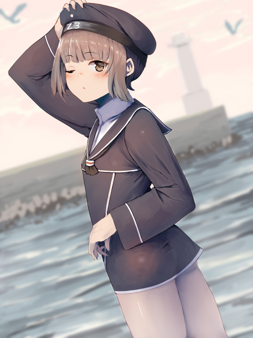 1girl bird blurry blurry_background brown_eyes brown_hair clothes_writing dress flat_chest hat highres honmakaina_kudou kantai_collection lighthouse long_sleeves outdoors sailor_dress sailor_hat short_hair solo standing z3_max_schultz_(kancolle)