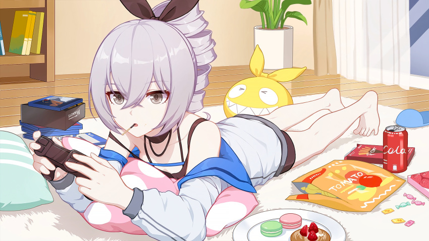 1girl :o bangs bare_shoulders barefoot book bookshelf bronya_zaychik can chips cola controller curtains drill_hair food fruit full_body grey_eyes grey_hair hair_between_eyes hair_ribbon highres holding holding_controller homu_(honkai_impact) honkai_(series) honkai_impact_3rd in_mouth indoors jacket liumang_tu_shua_p_zhan long_sleeves lying macaron on_stomach open_mouth pillow plant plate playing_games pocky ribbon slippers soda_can solo strawberry surprised sweets vase white_jacket window