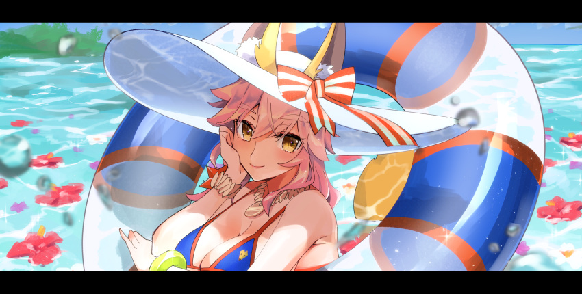 1girl animal_ears bikini blue_bikini breasts cleavage collarbone day ears_through_headwear fate/grand_order fate_(series) fox_ears fox_tail hat hat_ribbon highres innertube ka_(mauve_p) large_breasts ocean outdoors pink_hair ribbon side-tie_bikini solo sun_hat swimsuit tail tamamo_(fate)_(all) tamamo_no_mae_(swimsuit_lancer)_(fate) yellow_eyes