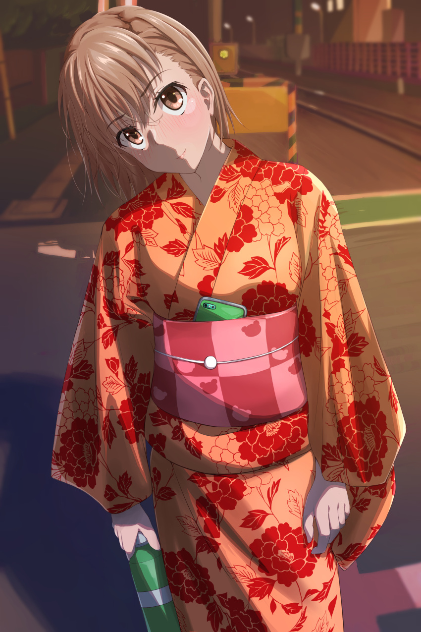 1girl absurdres arms_at_sides bangs blush bob_cut bottle brown_eyes brown_hair cellphone closed_mouth commentary cowboy_shot floral_print hair_between_eyes halya_meri head_tilt highres holding holding_bottle japanese_clothes kimono light_smile looking_at_viewer misaka_mikoto night nose_blush obi orange_kimono outdoors phone railroad_tracks sash short_hair smartphone solo toaru_kagaku_no_railgun toaru_majutsu_no_index