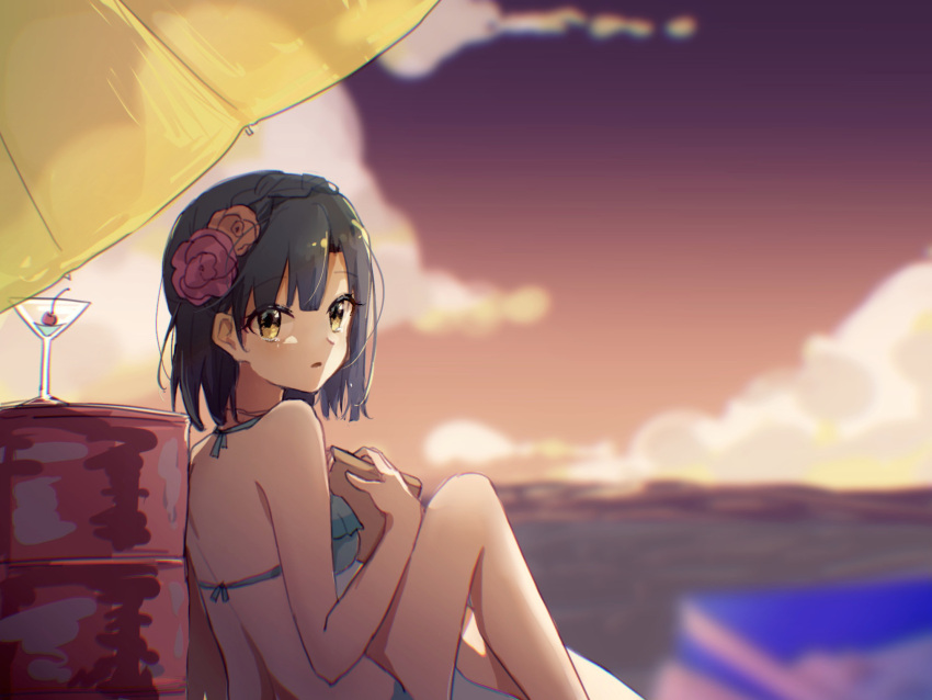 1girl :o bikini blurry blurry_foreground book braid cocktail_glass cup dark_blue_hair depth_of_field drinking_glass flower frilled_bikini frills hair_flower hair_ornament halterneck highres holding holding_book idolmaster idolmaster_million_live! knee_up looking_at_viewer looking_back nanao_yuriko nnnn outdoors short_hair sitting solo sunset swimsuit yellow_eyes