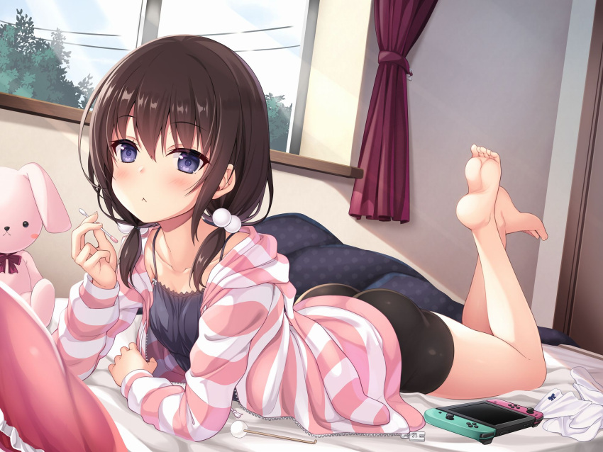 1girl :&lt; ass bangs bare_shoulders bed_sheet bike_shorts black_camisole black_shorts blanket brown_hair camisole collarbone cotton_swab curtains eyebrows_visible_through_hair feet feet_up hair_between_eyes hair_bobbles hair_ornament highres holding hood hoodie indoors light_rays looking_at_viewer lying medium_hair mimikaki nintendo_switch on_bed on_stomach original pillow power_lines short_twintails shorts socks socks_removed solo striped striped_hoodie stuffed_animal stuffed_bunny stuffed_toy sunbeam sunlight toes tree twintails utsurogi_akira violet_eyes white_legwear window