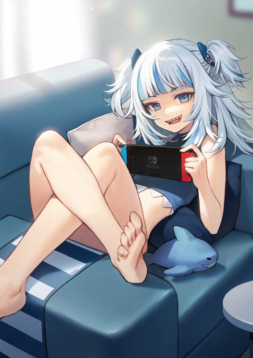 1girl :d absurdres bare_arms bare_legs bare_shoulders barefoot blue_eyes blue_shirt chair crop_top gawr_gura hair_ornament highres holding hololive hololive_english legs_up long_hair looking_at_viewer lying midriff multicolored_hair nintendo_switch on_back on_chair open_mouth osuti reclining sharp_teeth shirt sitting_sideways sleeveless sleeveless_shirt smile solo streaked_hair teeth two_side_up virtual_youtuber white_hair