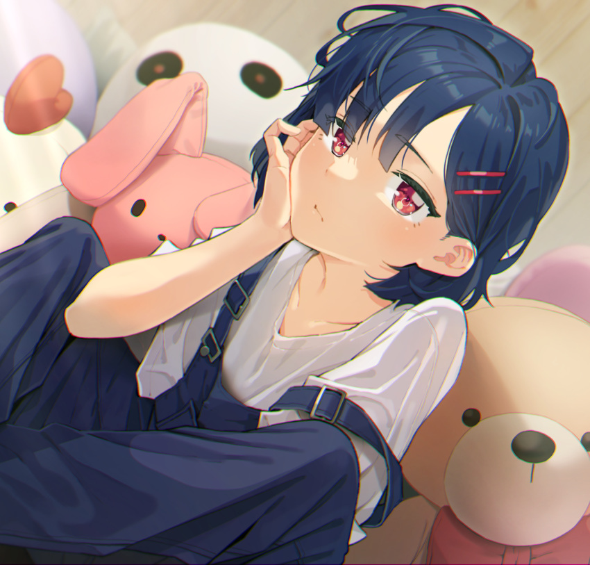 1girl agnamore bangs black_hair closed_mouth collarbone dutch_angle eyebrows_visible_through_hair hair_ornament hairclip hand_up highres indoors looking_at_viewer original overalls red_eyes shirt short_sleeves solo stuffed_animal stuffed_bunny stuffed_toy teddy_bear white_shirt