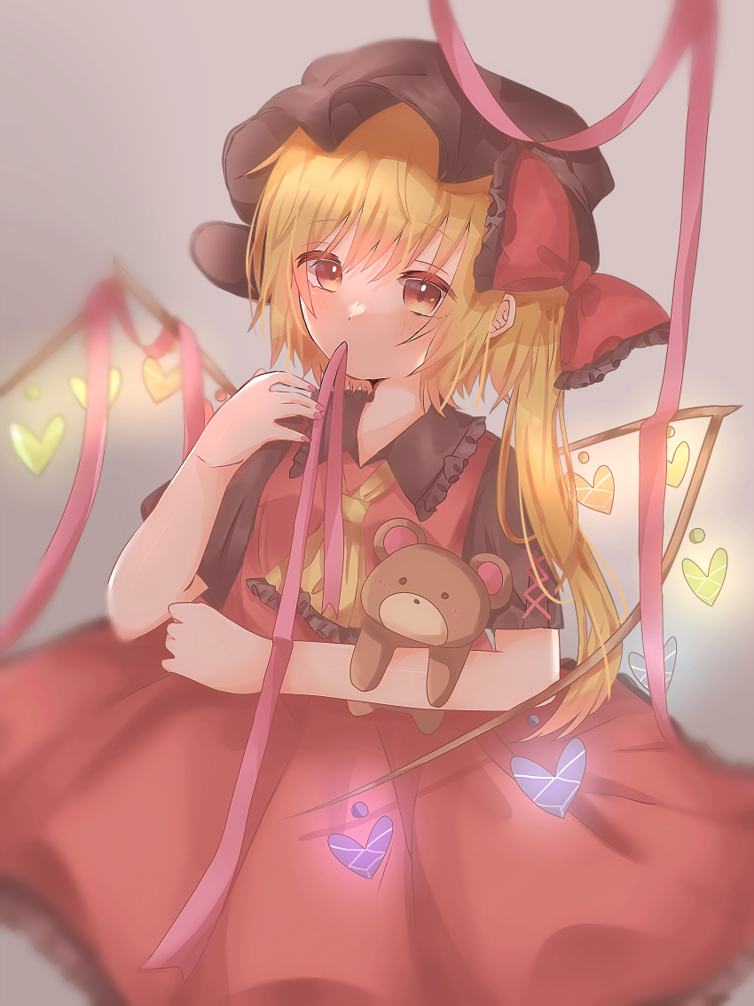 1girl absurdres alternate_costume alternate_wings artist_request ascot bangs black_headwear blurry blush bow commentary_request crystal depth_of_field dress eyebrows_visible_through_hair flandre_scarlet frilled_shirt_collar frills glowing grey_background hair_bow hand_up hat heart highres holding holding_stuffed_toy mob_cap mouth_hold nail_polish one_side_up red_bow red_dress red_nails ribbon soft_focus solo stuffed_animal stuffed_toy teddy_bear touhou wings yellow_neckwear