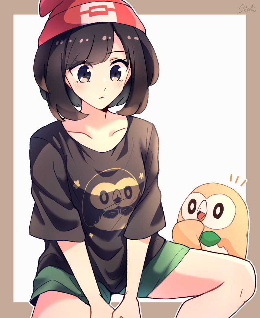 1girl beanie black_eyes blush border brown_border brown_shirt character_print collarbone commentary eyelashes green_shorts hat highres knees looking_down notice_lines outline parted_lips pokemon pokemon_(creature) pokemon_(game) pokemon_sm red_headwear rowlet selene_(pokemon) shirt shorts signature sitting spread_legs tere_asahi
