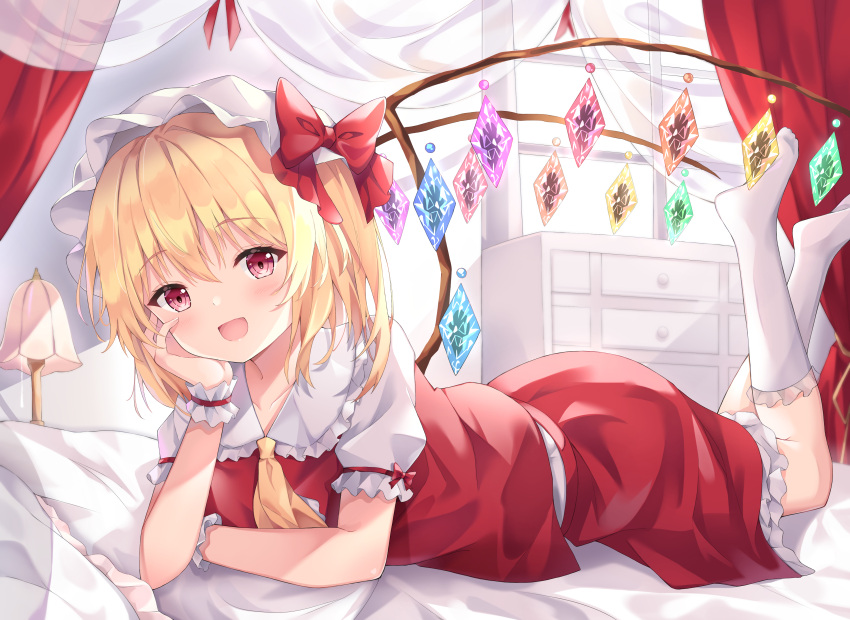1girl absurdres ascot blonde_hair blush collarbone commentary_request crystal curtains eyebrows_visible_through_hair flandre_scarlet hair_between_eyes hair_ribbon hand_on_own_face hat highres kofumi_(nxme5555) lamp looking_at_viewer lying medium_hair on_bed on_stomach open_mouth puffy_short_sleeves puffy_sleeves red_eyes red_skirt red_vest ribbon shirt short_sleeves side_ponytail skirt socks solo touhou vest white_shirt wings wristband yellow_neckwear