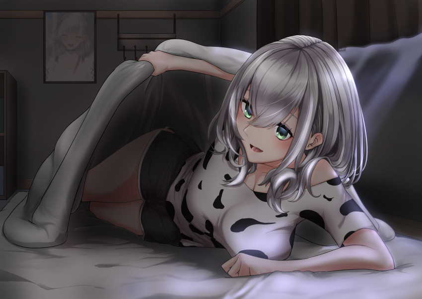 1girl :d absurdres animal_print bangs blanket breasts cow_print green_eyes hair_between_eyes highres hololive kagamimaru large_breasts lifting_covers open_mouth shirogane_noel short_hair shorts silver_hair smile solo virtual_youtuber