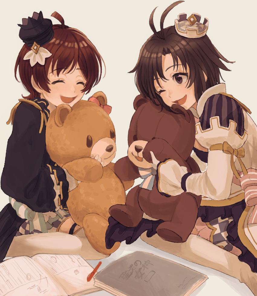 2girls ^_^ absurdres ahoge antenna_hair black_hair closed_eyes costume crown facing_another frills grey_eyes hair_ornament hairclip highres idolmaster idolmaster_million_live! idolmaster_million_live!_theater_days kikuchi_makoto kinoshita_hinata multiple_girls notebook one_eye_closed pen short_hair sitting smile stuffed_animal stuffed_toy tanupon teddy_bear