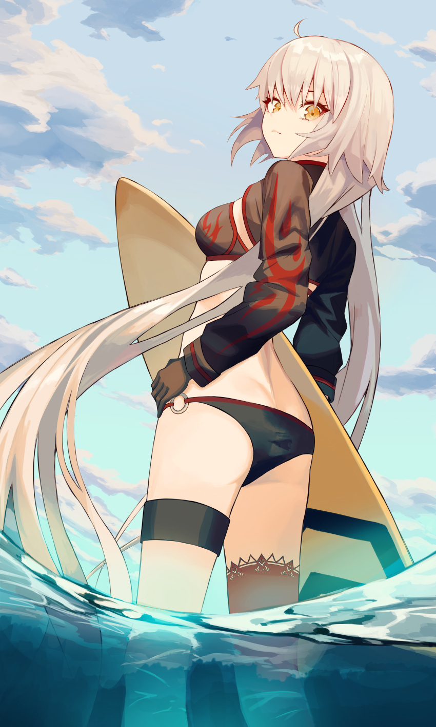 1girl absurdres ahoge ass bangs beach bikini black_bikini black_gloves black_jacket blue_sky breasts cropped_jacket fate/grand_order fate_(series) gloves highres jacket jeanne_d'arc_(alter_swimsuit_berserker)_(fate) jeanne_d'arc_(fate) large_breasts long_hair long_sleeves looking_at_viewer moseong o-ring o-ring_bikini ocean red_legwear shrug_(clothing) silver_hair single_thighhigh sky solo surfboard swimsuit thigh-highs thigh_strap thighs very_long_hair wading yellow_eyes