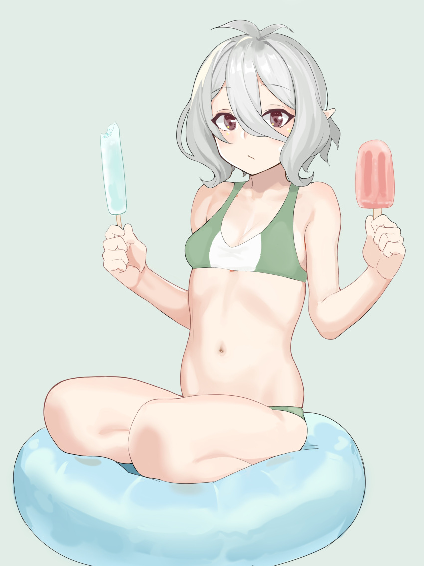 1girl absurdres antenna_hair bangs bikini breasts brown_eyes closed_mouth cushion elf eyebrows_visible_through_hair food green_background grey_hair hair_between_eyes highres holding hoshiya_takahito kokkoro_(princess_connect!) looking_at_viewer navel pointy_ears popsicle princess_connect! short_hair simple_background sitting small_breasts solo stomach swimsuit