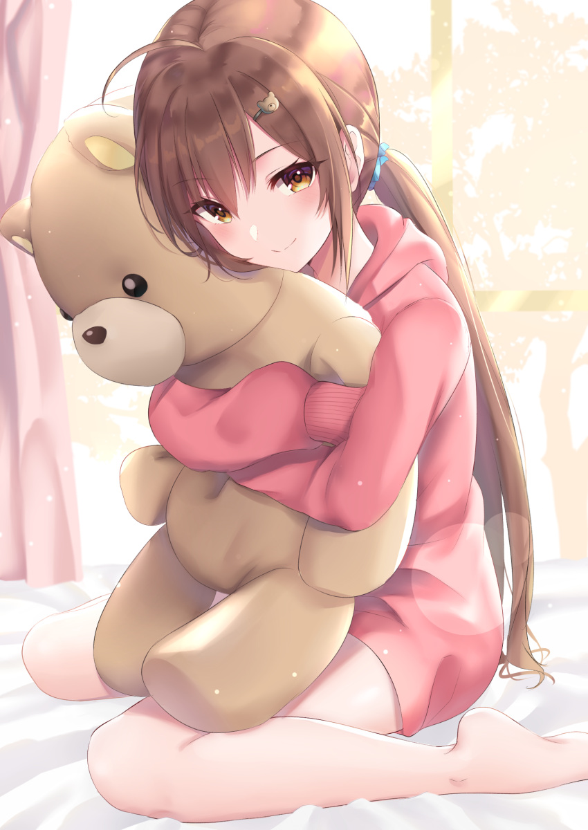 1girl ahoge bangs barefoot bear_hair_ornament bed_sheet brown_eyes brown_hair closed_mouth commentary_request curtains eyebrows_visible_through_hair hair_between_eyes hair_ornament hairclip highres hood hood_down hoodie indoors long_hair long_sleeves looking_at_viewer low_ponytail object_hug original pink_hoodie ponytail sitting sleeves_past_fingers sleeves_past_wrists smile solo stuffed_animal stuffed_toy teddy_bear very_long_hair wariza wasami_(a27678193a) window