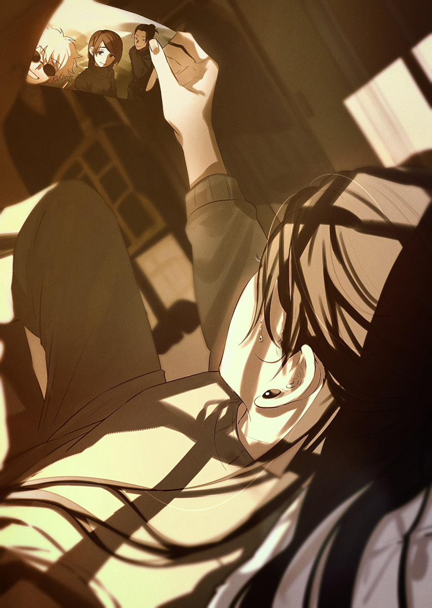 1boy bangs black_hair closed_mouth cowboy_shot ear_piercing getou_suguru gojou_satoru grey_pants grey_sweater grin hair_bun hand_up highres holding_picture ieiri_shoko indoors jujutsu_kaisen kuropani_cos long_hair long_sleeves lying male_focus on_back pants piercing round_eyewear short_hair smile solo sunglasses sweater swept_bangs tears white_hair