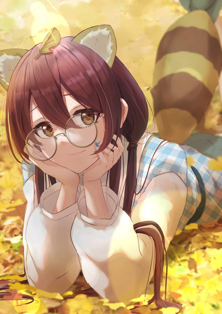1girl absurdres animal_ear_fluff animal_ears bespectacled blurry blush bokeh depth_of_field ginkgo_leaf glasses hair_between_eyes hands_on_own_cheeks hands_on_own_face head_rest highres idolmaster idolmaster_shiny_colors leaf leaf_on_head long_sleeves looking_at_viewer lying marishiten_(mar1sh110) nail_polish on_stomach oosaki_tenka plaid plaid_shirt raccoon_ears raccoon_tail redhead shirt smile solo tail twintails