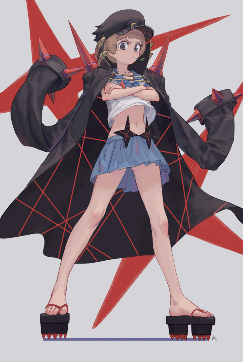 1girl absurdres banchou bob_cut brown_eyes brown_hair closed_mouth crescent crescent_hat_ornament crossed_arms full_body grey_background hat hat_ornament highres jacket jacket_on_shoulders kill_la_kill looking_at_viewer mankanshoku_mako max-k midriff mouth_hold pleated_skirt sandals school_uniform serafuku simple_background skirt solo spikes standing wind wind_lift