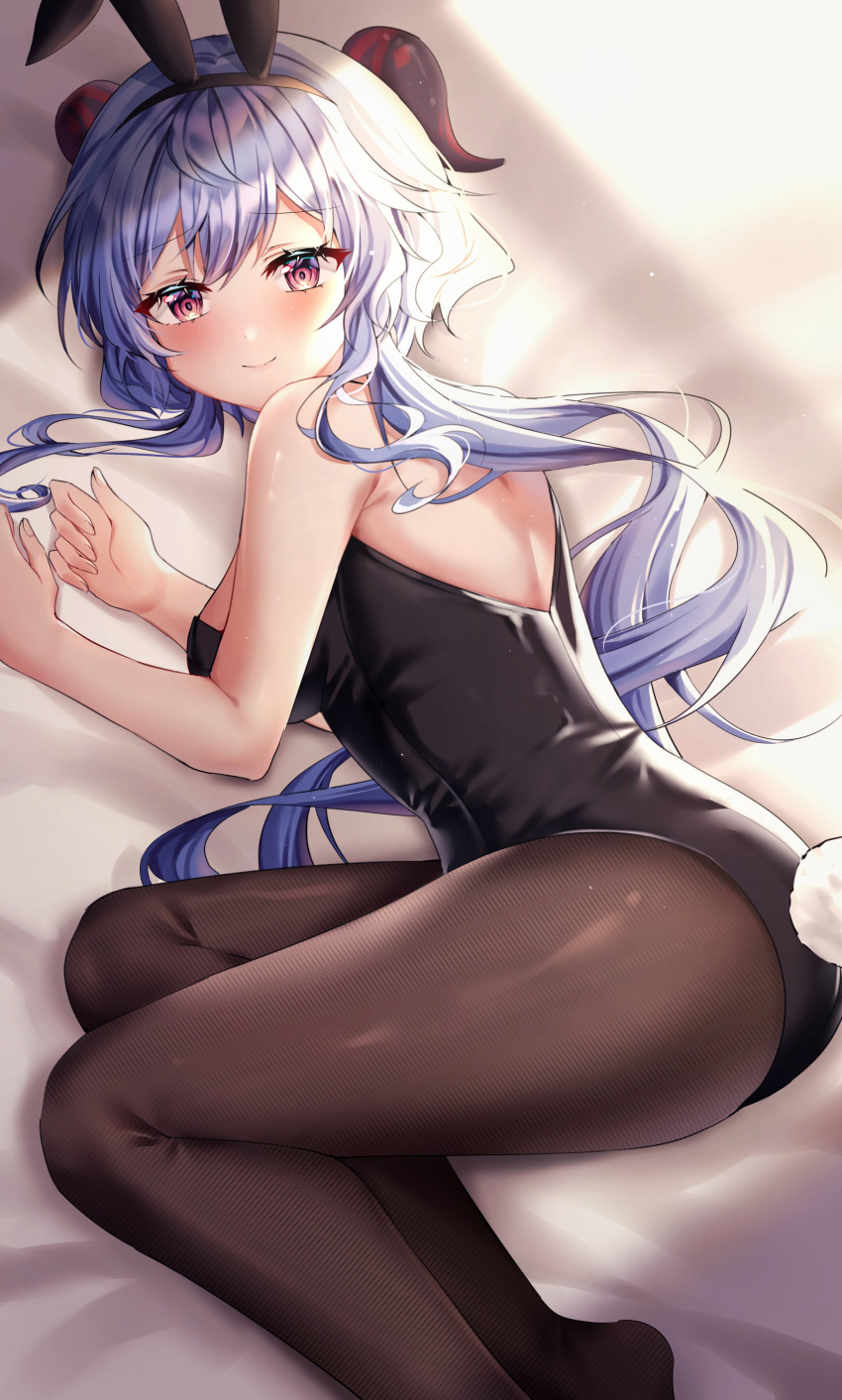 absurdres animal_ears bangs bed bed_sheet black_legwear black_leotard blue_hair blush curled_horns educk eyebrows_visible_through_hair ganyu_(genshin_impact) genshin_impact highres horns leotard long_hair looking_at_viewer low_ponytail lying multicolored_eyes on_side pantyhose playboy_bunny rabbit_ears rabbit_tail smile solo tail