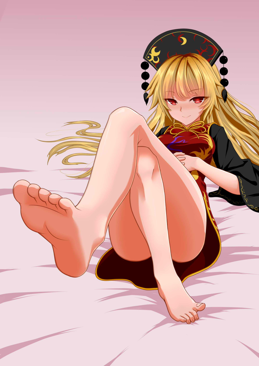 1girl absurdres animal_print bangs bare_legs barefoot bed bird bird_print black_dress black_headwear blonde_hair blush bow bowtie breasts c.rabbit chinese_clothes closed_mouth crescent crossed_legs dress eyebrows_visible_through_hair eyes_visible_through_hair hair_between_eyes hat highres junko_(touhou) legs long_hair long_sleeves looking_at_viewer medium_breasts phoenix phoenix_crown pom_pom_(clothes) red_eyes red_vest sitting smile soles solo tabard touhou vest wide_sleeves yellow_bow yellow_bowtie