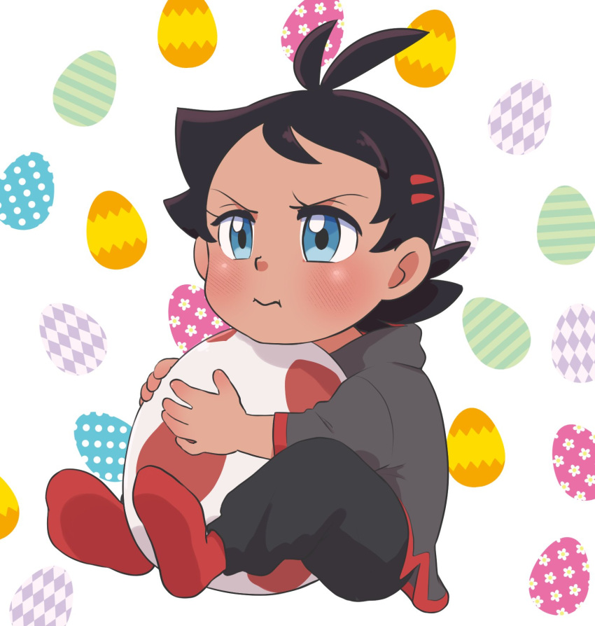 1boy :i antenna_hair black_pants blue_eyes blush brown_hair closed_mouth commentary_request egg egg_background eyelashes goh_(pokemon) grey_shirt highres holding holding_egg kawachaneel male_focus medium_hair pants pokemon pokemon_(anime) pokemon_swsh_(anime) pout red_legwear shirt socks solo younger