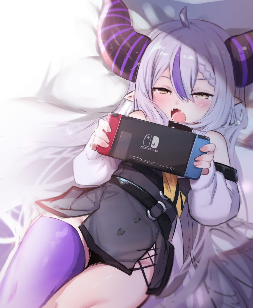 1girl absurdres bare_shoulders belt blush braid fang hair_between_eyes highres hololive horns la+_darknesss long_hair lying nintendo_switch on_back open_mouth pillow pointy_ears purple_hair purple_legwear silver_hair single_thighhigh solo thigh-highs utsusumi_kio very_long_hair virtual_youtuber yellow_eyes