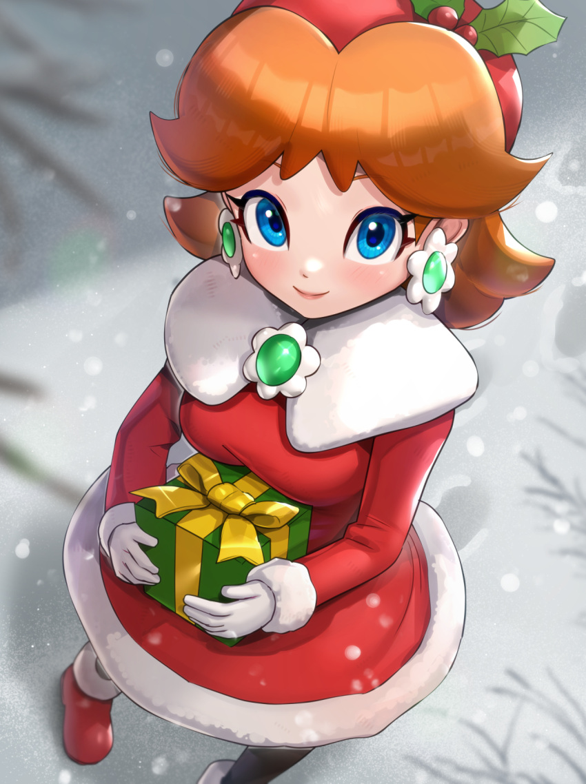 1girl black_legwear blue_eyes breasts brooch brown_hair earrings from_above gift gloves gonzarez highres holding holding_gift jewelry medium_breasts outdoors princess_daisy red_footwear santa_costume santa_dress snow solo super_mario_bros. white_gloves