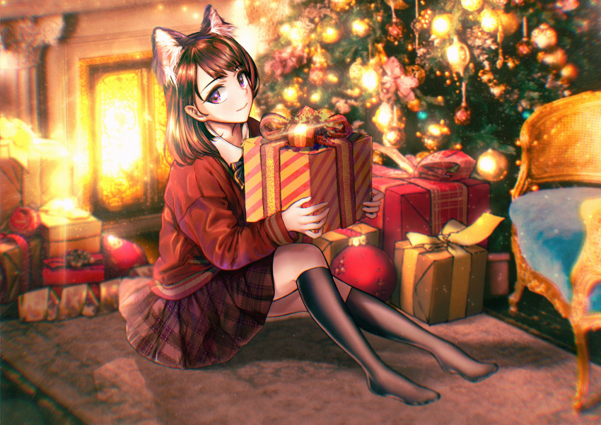 1girl absurdres animal_ears bangs black_legwear blush brown_hair cat_ears chair christmas christmas_tree fireplace gift highres holding indoors irum looking_at_viewer mat original school_uniform sitting smile solo uniform violet_eyes