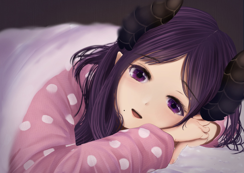 1girl :d bangs bed_sheet dc24v honey_strap horns long_hair long_sleeves looking_at_viewer lying mole mole_under_eye on_stomach parted_bangs pink_sleeves polka_dot_sleeves purple_hair saionji_mary smile solo tears under_covers violet_eyes virtual_youtuber