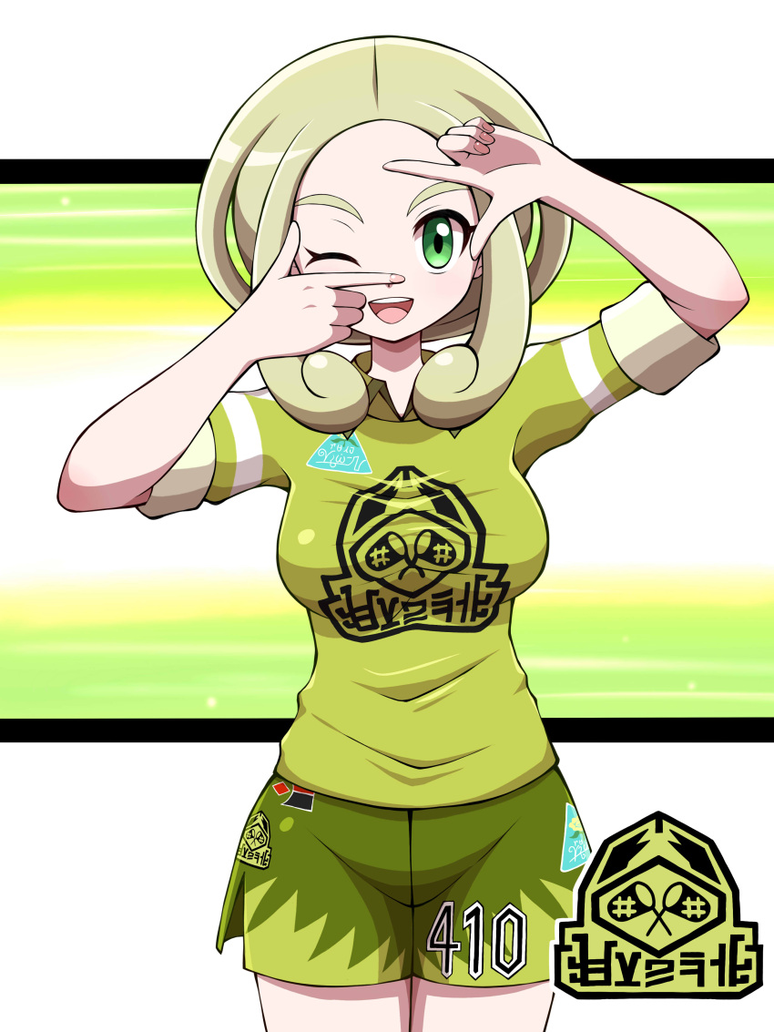 1girl ;d absurdres alternate_costume blonde_hair breasts commentary_request finger_frame green_eyes green_shirt green_shorts gym_challenge_uniform hands_up highres jersey large_breasts medium_hair one_eye_closed open_mouth pokemon pokemon_(game) pokemon_swsh pokemon_xy shabana_may shirt shorts smile solo sportswear t-shirt uniform_number viola_(pokemon)