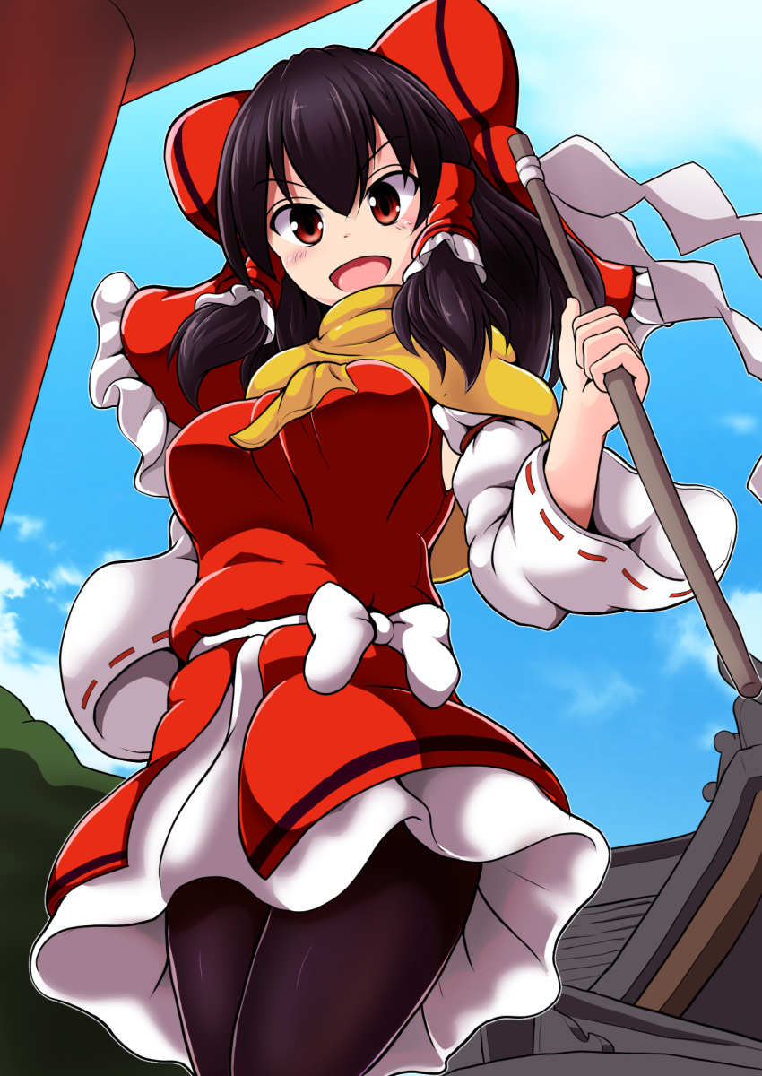 1girl :d architecture bangs black_legwear blue_sky bow breasts brown_hair clouds cloudy_sky east_asian_architecture gohei hair_bow hakurei_reimu highres holding japanese_clothes long_hair long_sleeves looking_at_viewer miko nioti open_mouth outdoors pantyhose red_eyes scarf sky smile solo touhou yellow_scarf