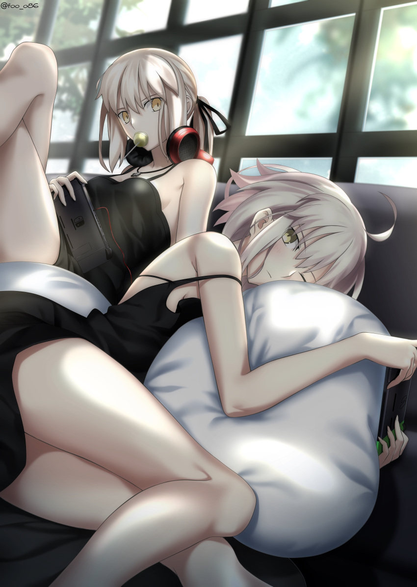 2girls absurdres ahoge artoria_pendragon_(fate) black_ribbon blush breasts candy clothes_lift cross cross_necklace crossed_legs fate/grand_order fate_(series) foo_(pixiv54892036) food headphones highres jet_black_king_of_knights_ver._shinjuku_1999 jewelry lollipop looking_at_viewer multiple_girls necklace nintendo_switch off_shoulder one_eye_closed ribbon saber_alter shirt_lift small_breasts