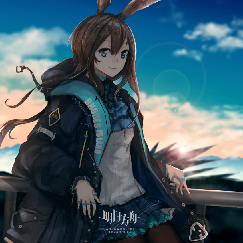 1girl amiya_(arknights) animal_ears anonamos arknights artist_name blue_eyes blurry blurry_background brown_hair clothes_writing clouds coat commentary day flare hair_between_eyes highres jewelry long_hair long_sleeves looking_at_viewer multiple_rings rabbit_ears ring smile solo