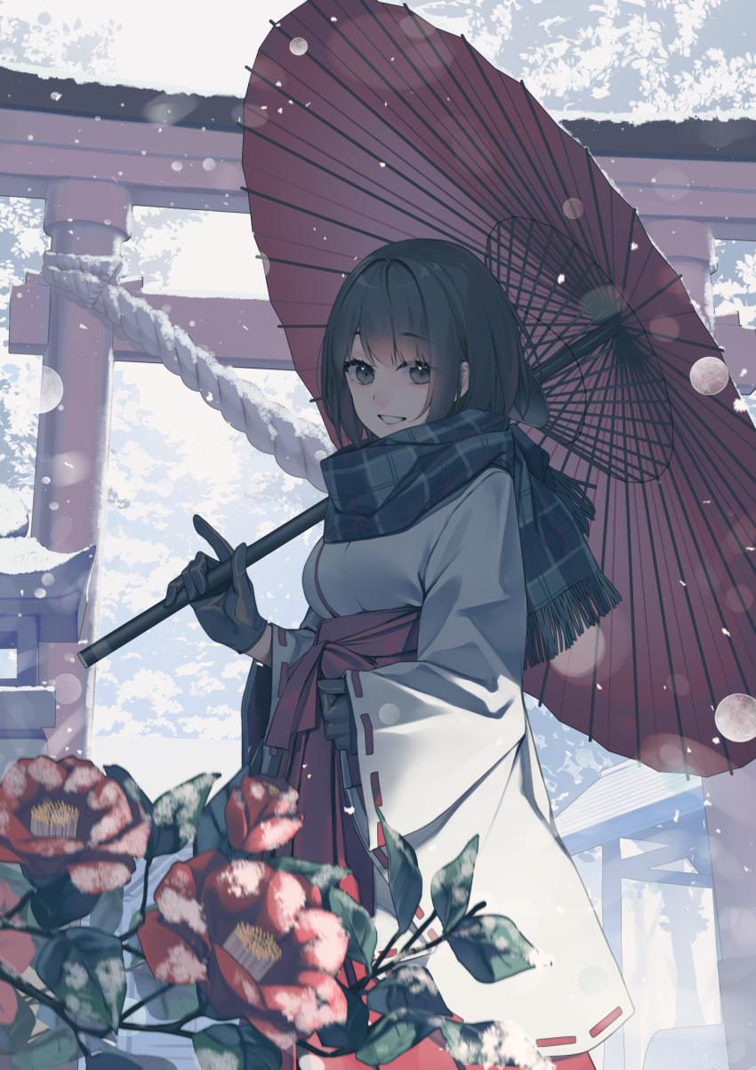 1girl bangs black_eyes black_gloves black_hair commentary_request eyebrows_visible_through_hair flower gloves grin hakama highres holding holding_umbrella japanese_clothes kimono long_sleeves looking_at_viewer oil-paper_umbrella original plaid plaid_scarf red_flower red_hakama rerrere ribbon-trimmed_sleeves ribbon_trim scarf short_hair smile snowing solo torii umbrella white_kimono