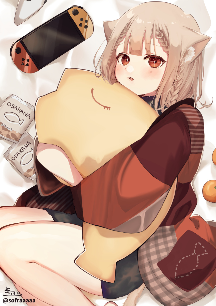 +_+ 1girl absurdres animal_ears bed_sheet black_shorts blush braid brown_eyes brown_hair cat_ears cat_girl cat_tail commentary_request controller fang food fruit game_controller highres long_hair long_sleeves looking_at_viewer lying mandarin_orange nintendo_switch object_hug on_side original parted_lips romaji_text short_shorts shorts signature sofra solo stuffed_animal stuffed_fish stuffed_toy tail twitter_username wide_sleeves
