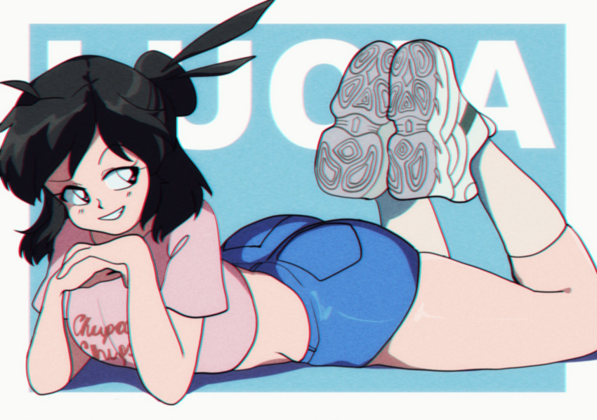 1girl artist_name ass black_hair blue_background blue_shorts borrowed_character brown_eyes crop_top full_body highres lucia_(scott_malin) lying medium_hair midriff on_stomach original parted_lips pink_shirt print_shirt purinworks shirt shoes short_sleeves shorts smile socks solo white_footwear