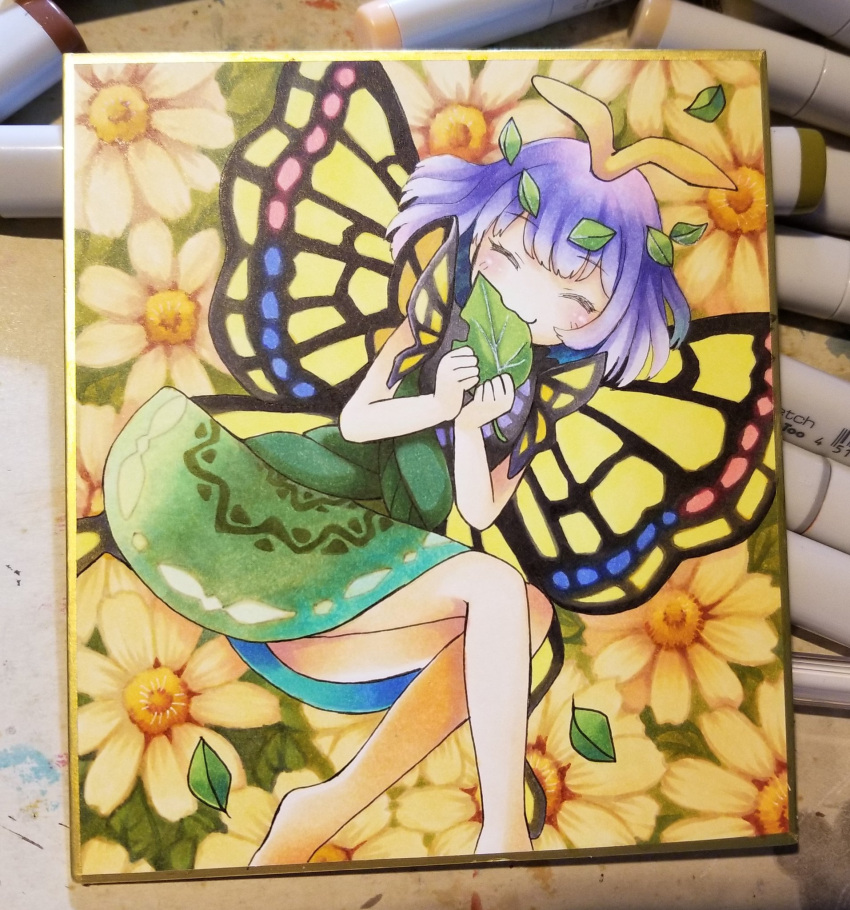 1girl antennae aqua_hair barefoot blush butterfly_wings closed_eyes closed_mouth dress eating eternity_larva eyebrows_visible_through_hair fairy flower green_dress highres holding holding_leaf leaf leaf_on_head multicolored_clothes multicolored_dress photo_(medium) proton shikishi short_hair short_sleeves smile solo third-party_source touhou wings yellow_flower