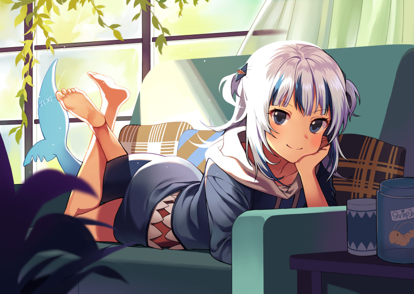 1girl bangs barefoot blue_eyes blue_hair blue_hoodie closed_mouth commentary couch cup curtains cushion day english_commentary eyebrows_visible_through_hair feet_up fish_tail full_body gawr_gura hair_ornament hand_on_own_chin hand_up head_rest highres hololive hololive_english hood hood_down hoodie indoors light_rays looking_at_viewer lying medium_hair multicolored_hair on_couch on_stomach plant shark_hair_ornament shark_tail silver_hair smile solo streaked_hair sunbeam sunlight tail toes two_side_up virtual_youtuber window yunoo_(cmzkvneld845)